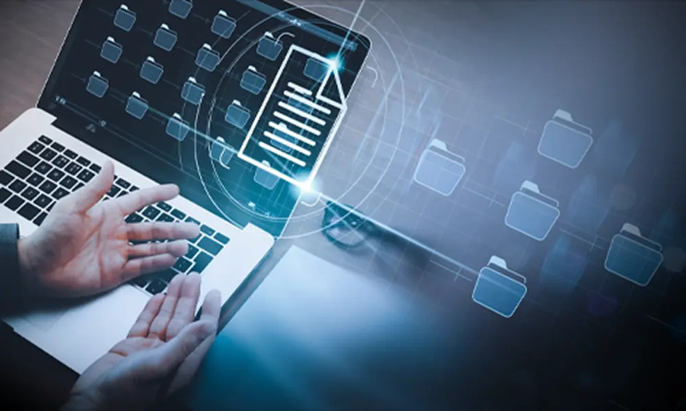 Open hands (palms up) resting on a laptop with a grid of folder icons on screen. In the luminal space, there is a stylized overlay of those folders.